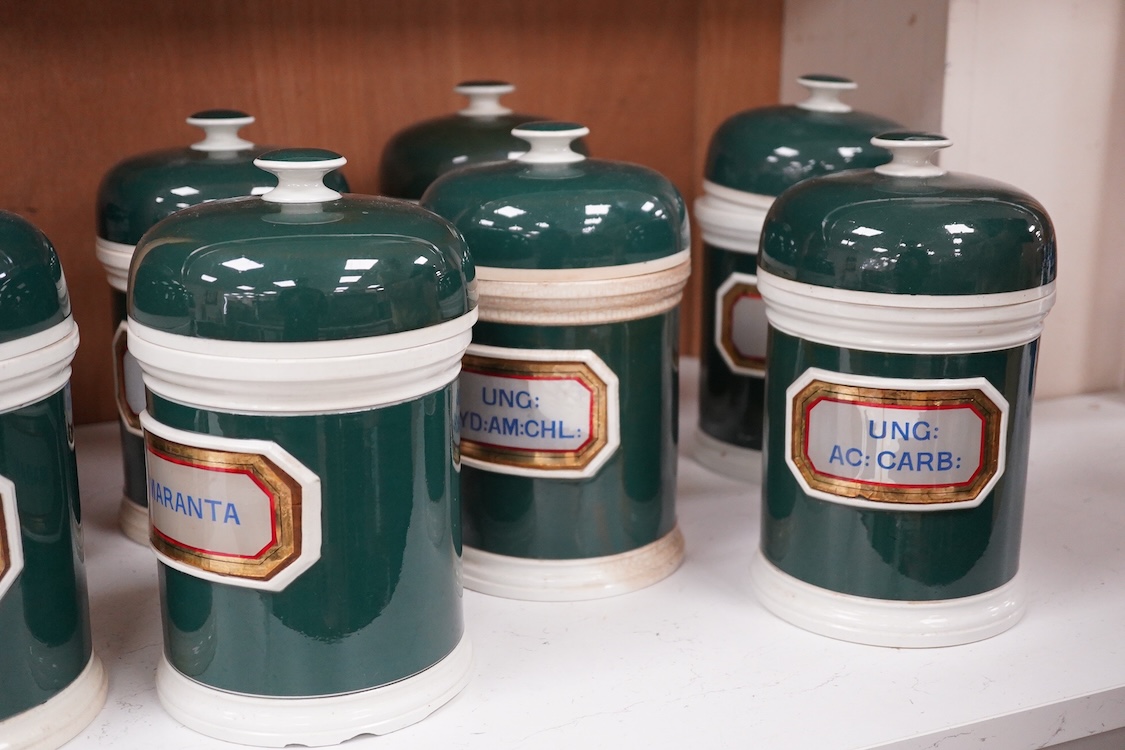 A collection of sixteen 19th/early 20th century ceramic lidded green apothecary jars, with labels painted within panels with raised ceramic edges and gilt lined, examples including; Ung: Zinci, Ung: Sulphur:, Mel: Boraci